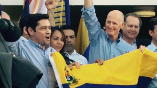Rick Scott, Carlos Vecchio